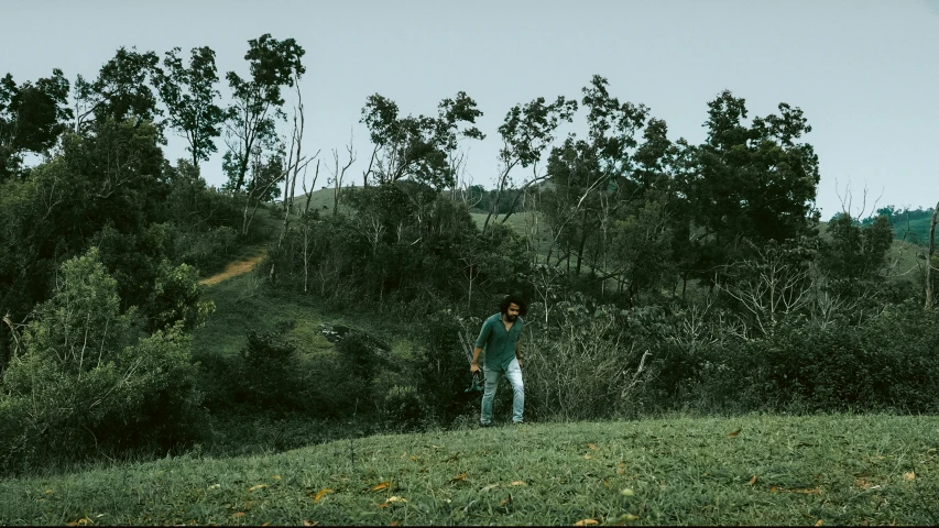 two people are playing in the woods with their kite