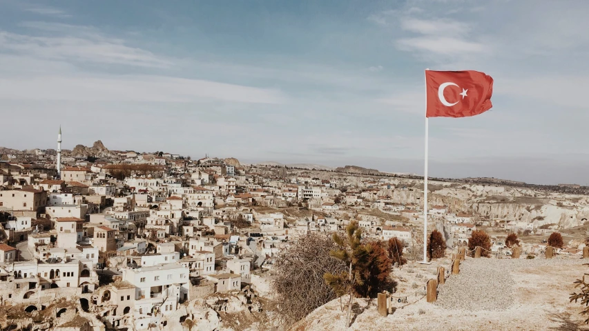 a flag flying on top of a town in turkey