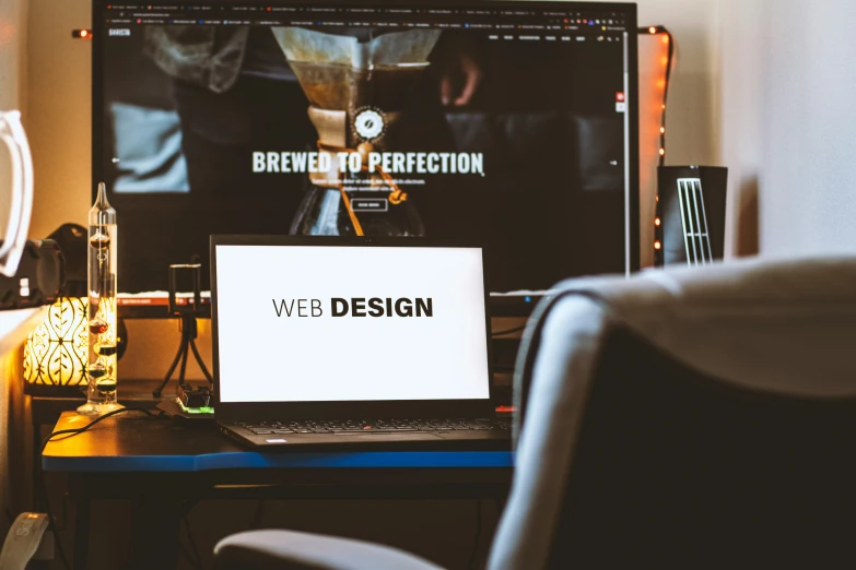 a monitor on a desk that says web design
