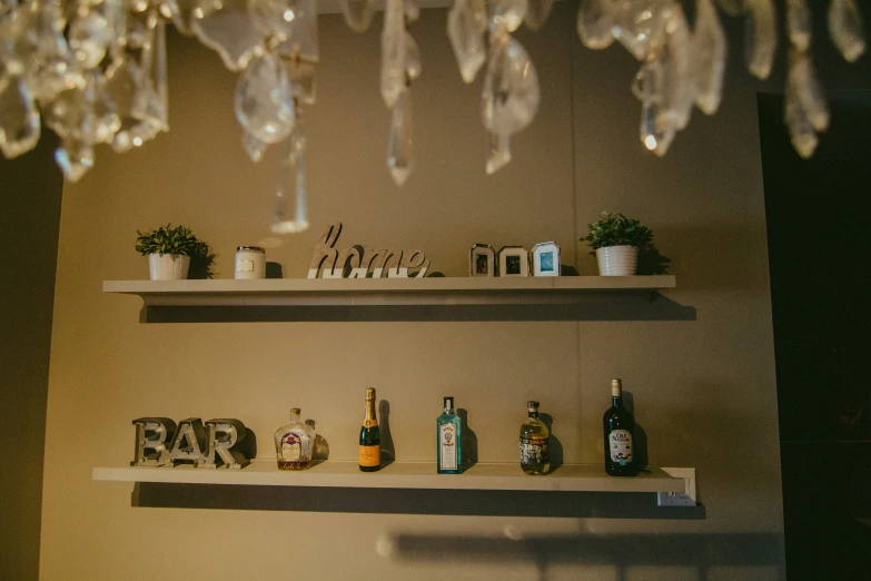 some bottles and a sign on shelves in the corner