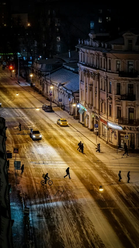 a city street at night with street lights and vehicles on the side