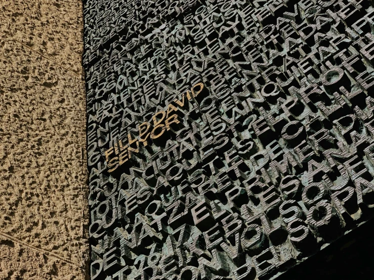 a black and yellow rug with letters printed on it