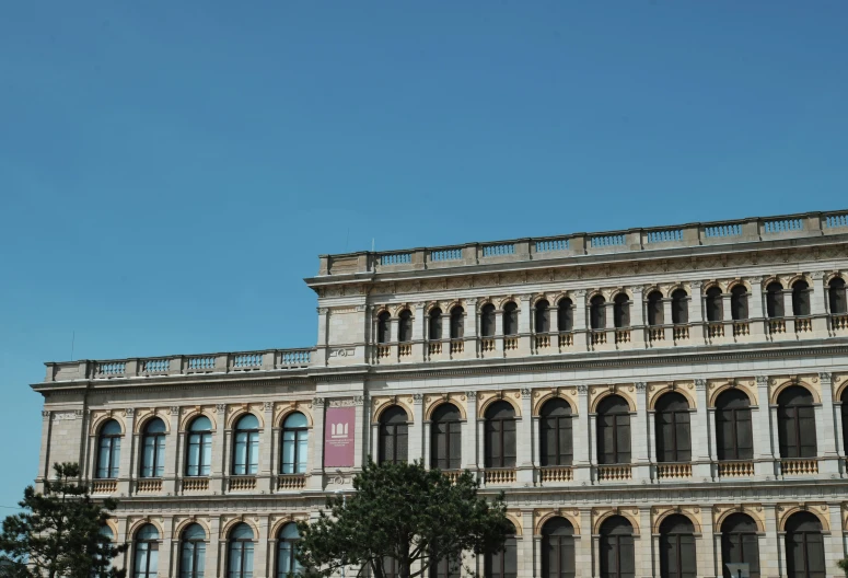 an old building with many windows and balconies on the top level