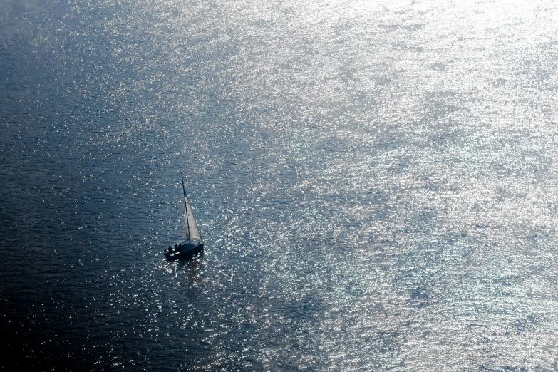 a sail boat is floating in some very choppy water