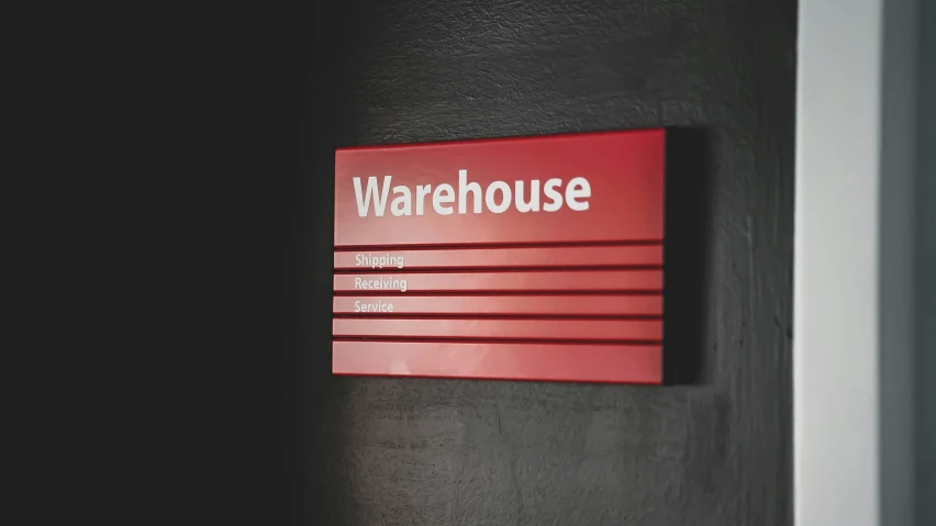 red warehouse sign mounted on the wall of a room