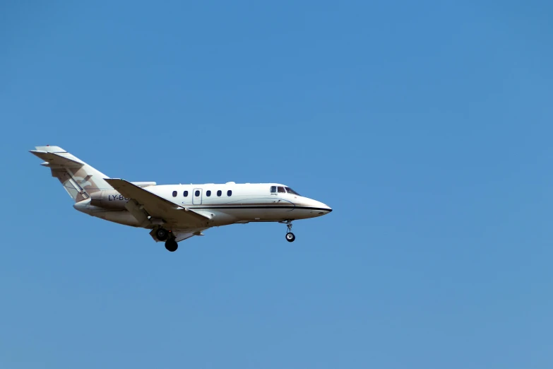 an airplane is flying in the air in a blue sky