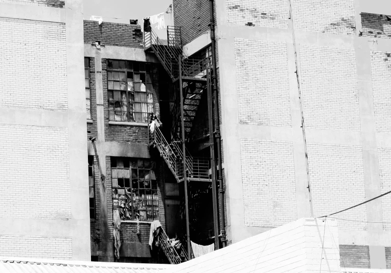 a person climbing up a steep stairs in black and white