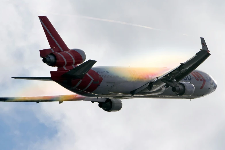 a jet plane flying through a cloudy blue sky