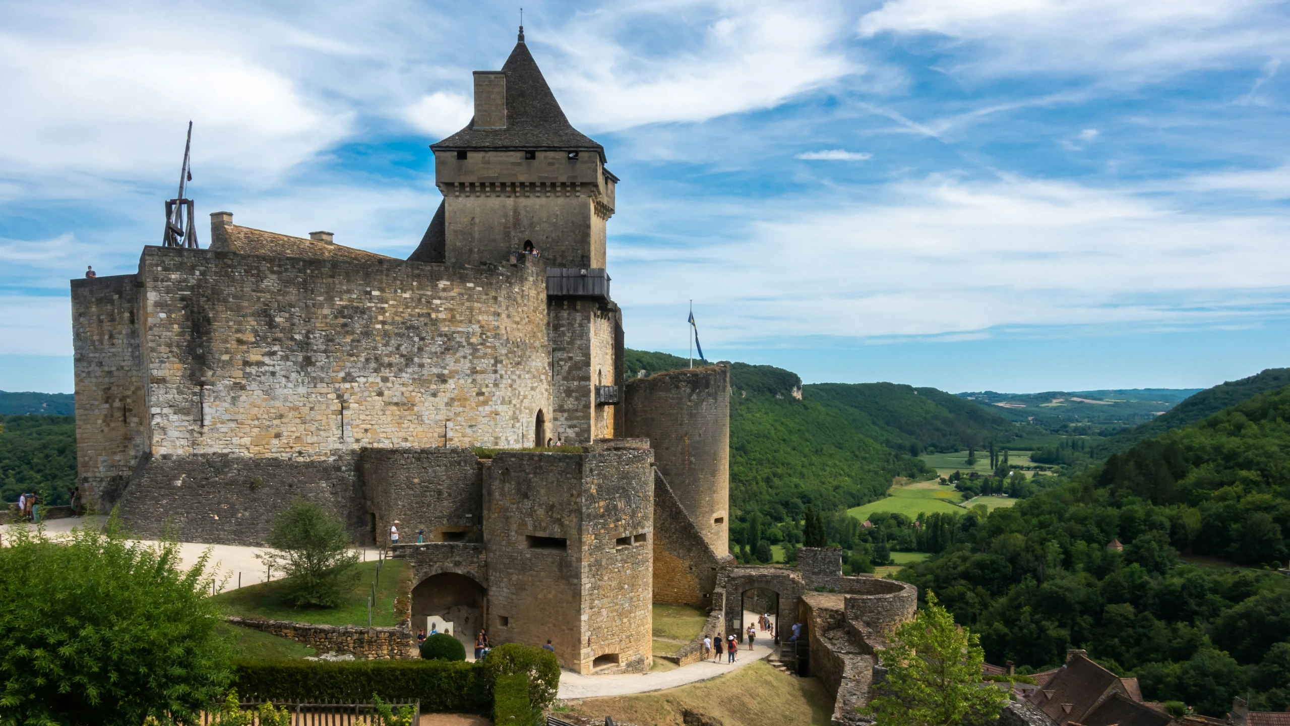 a castle that is surrounded by trees and hills