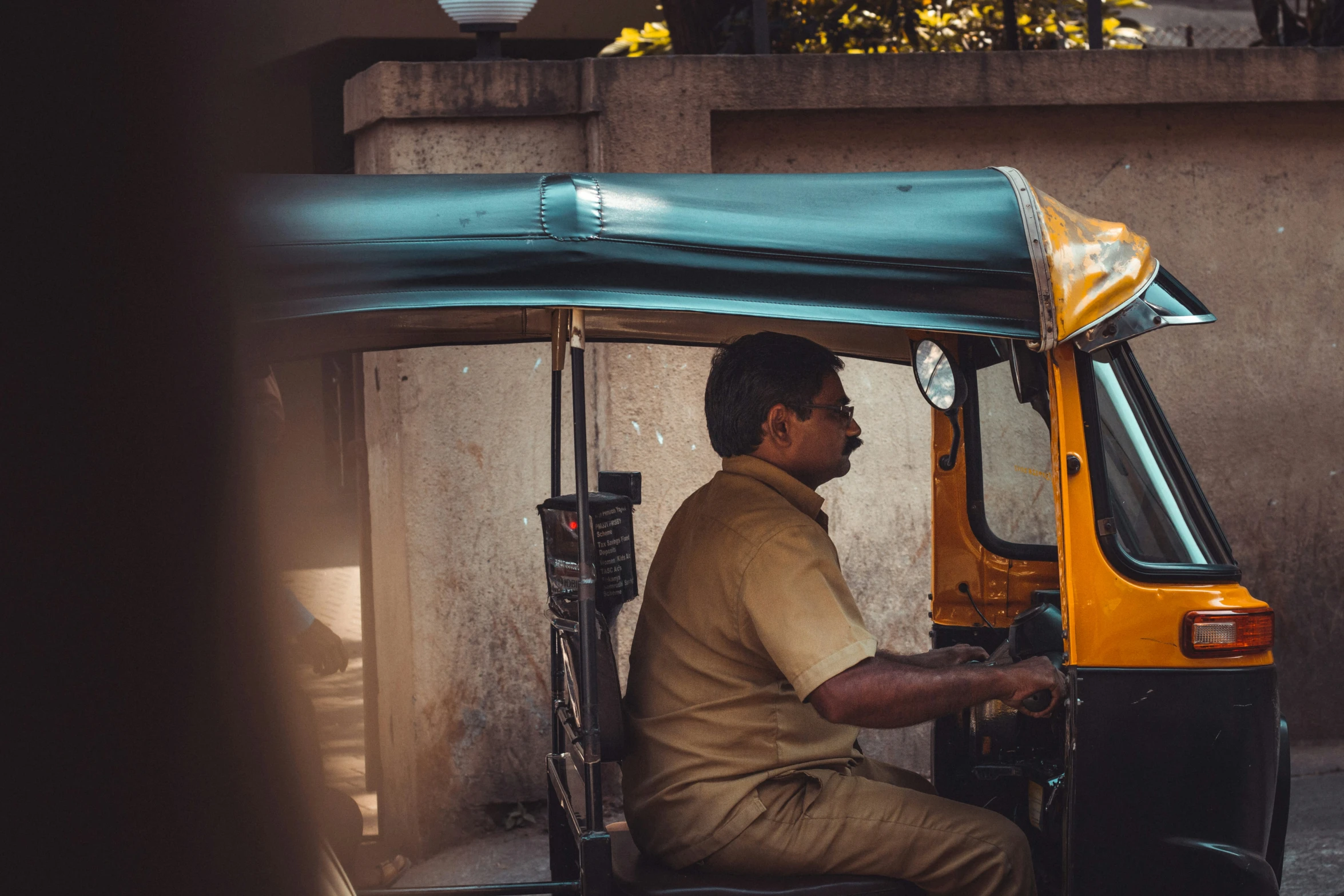 a man sits in a cart next to a building