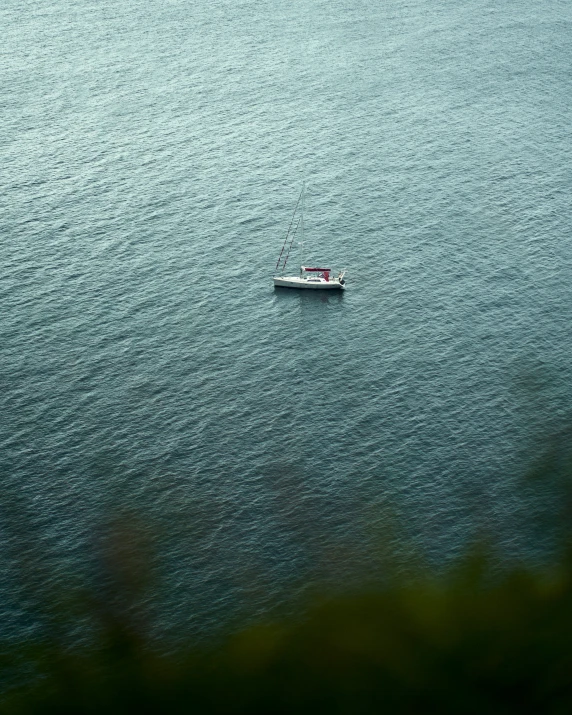 a boat in the middle of an ocean near shore