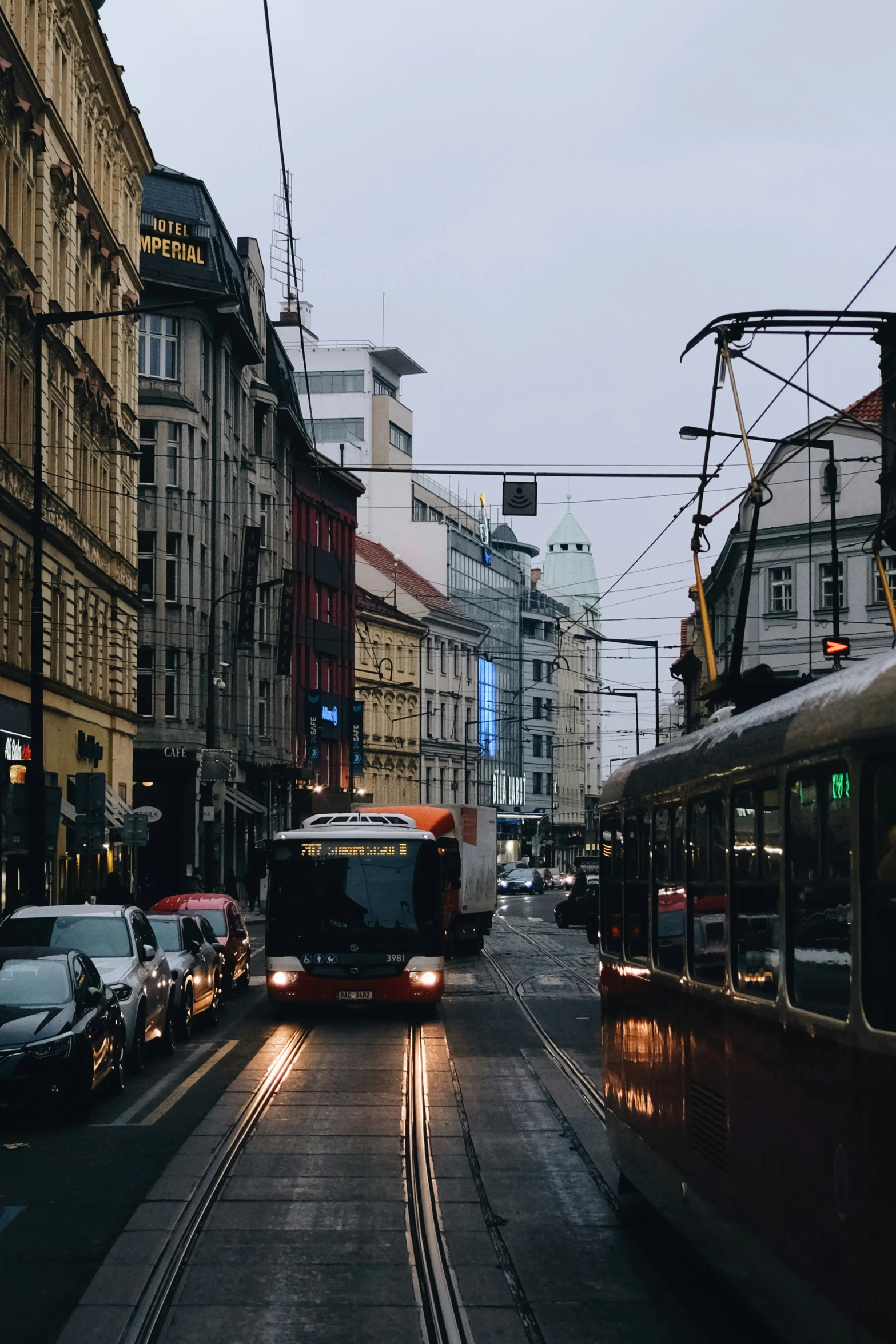 buses and cars driving through the city streets