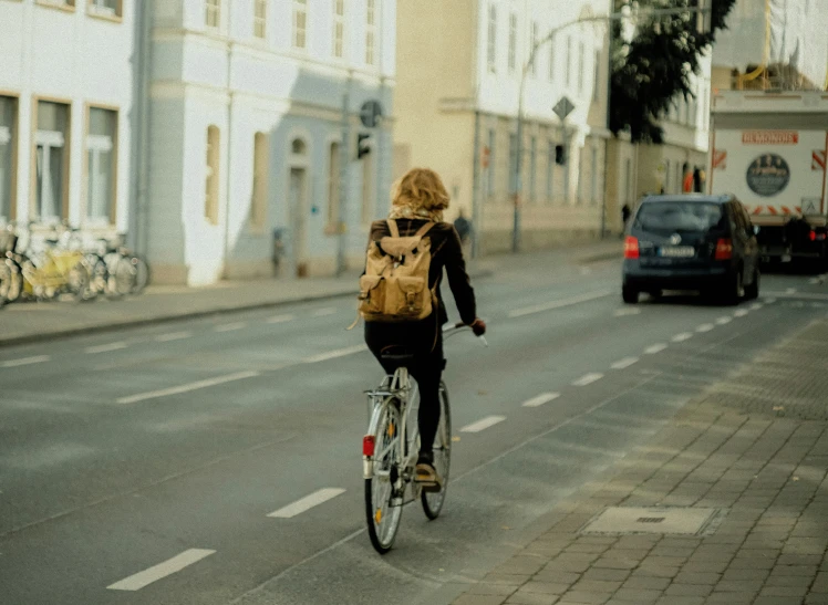 the man on a bike has a backpack over his back