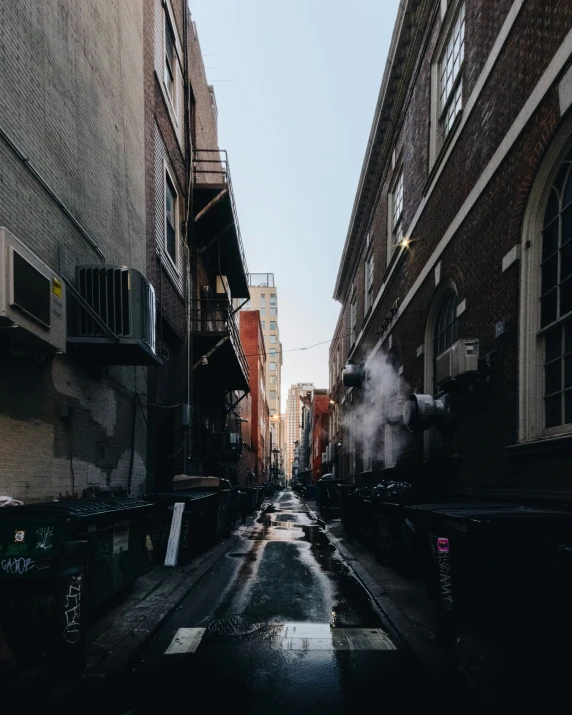 an old train on a city street with smoke coming out