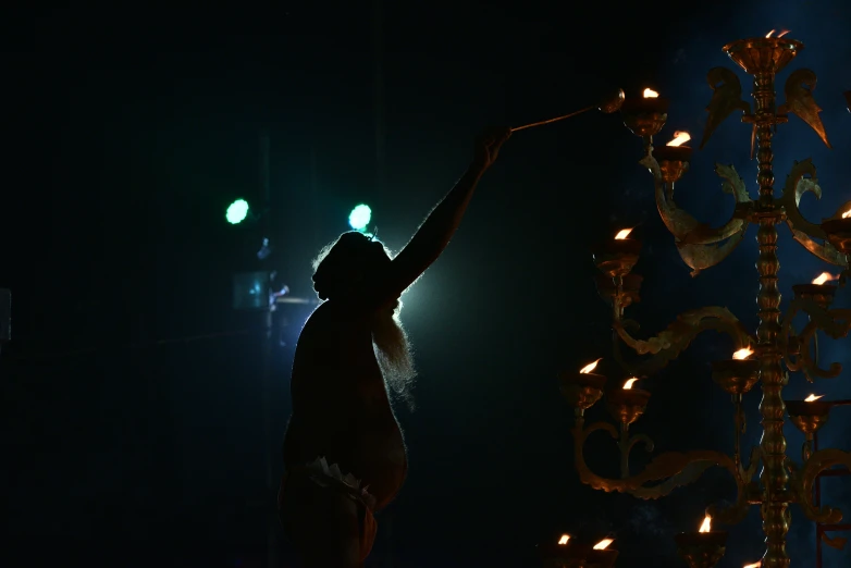 a woman standing next to a giant lit up figure