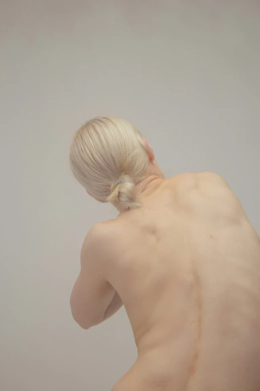 a  woman with blonde hair is in a white room