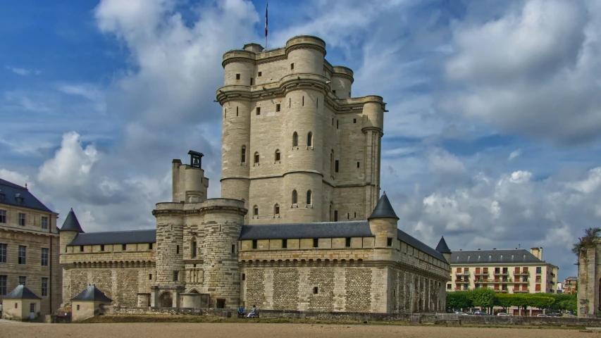 large castle sitting on top of a sandy field