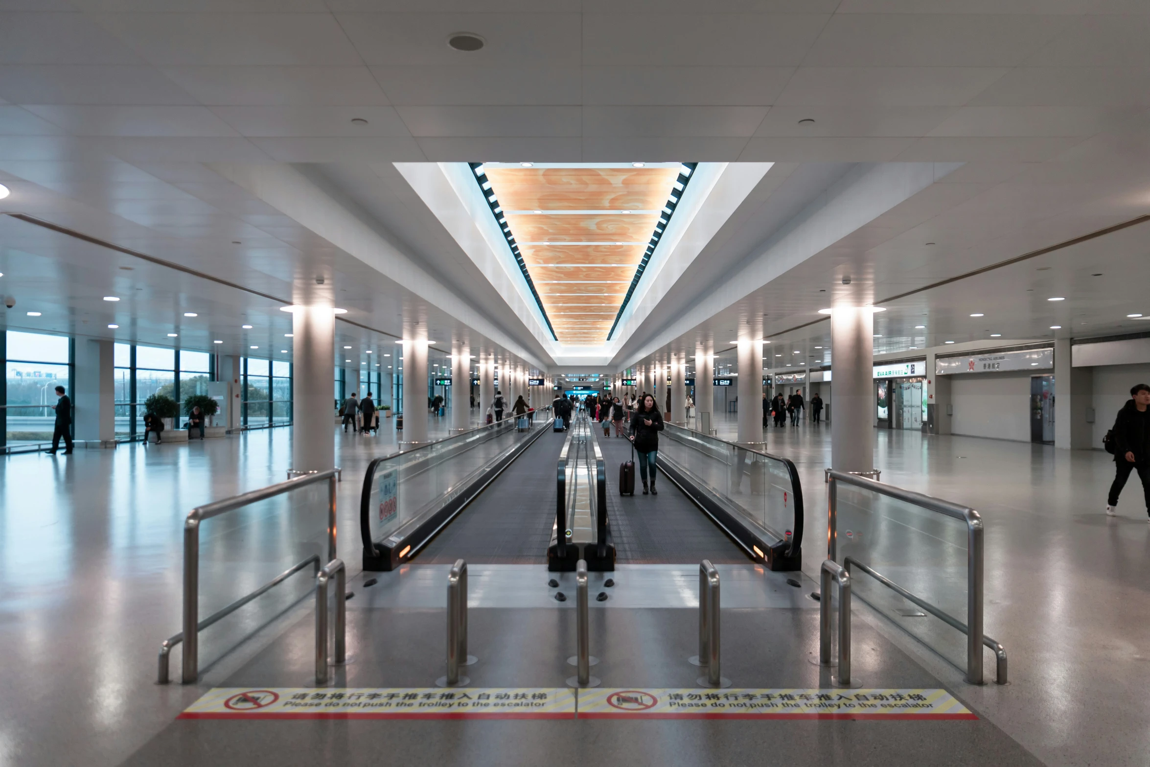 the inside of an airport with a few people moving around