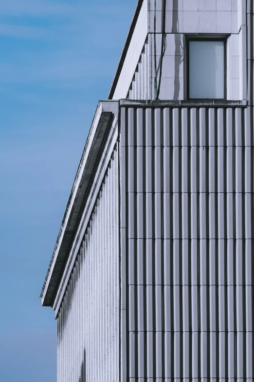 a tall white building sitting next to a light tower