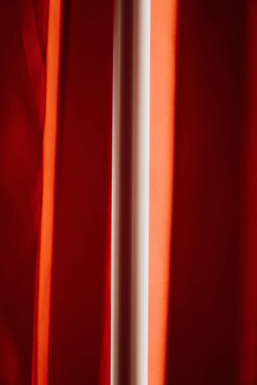 close up view of red fabric and the back side of the curtain