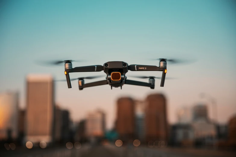 a large black flying in the sky over a city