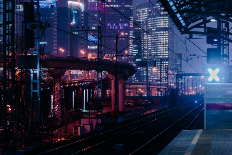 a city train on a train track at night