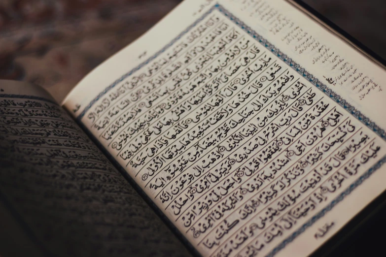 a book opened to an arabic language on a table