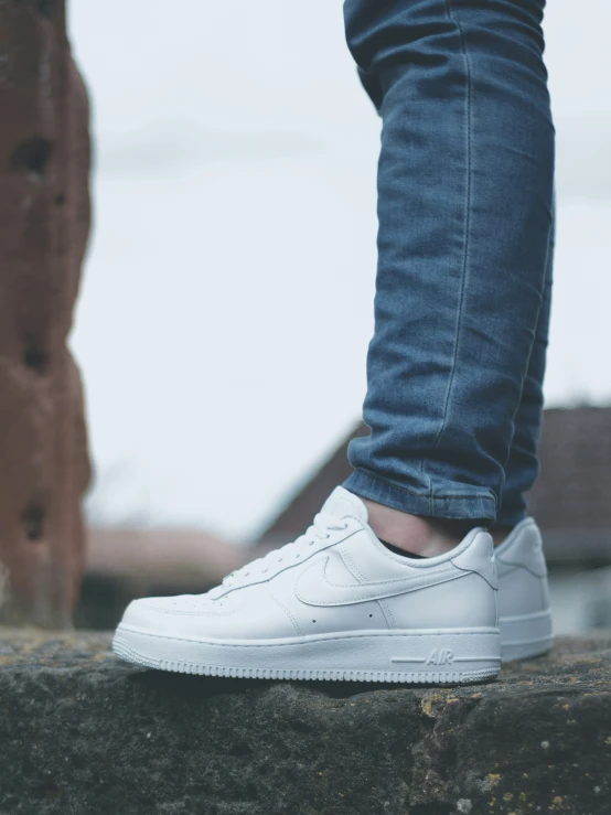 someone standing with their feet in the air on a stone ledge