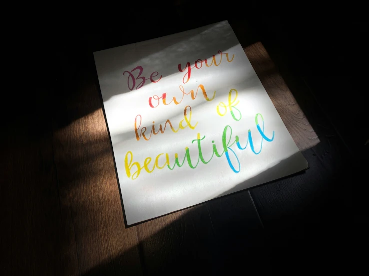 a po of a paper with the words be your own kind of beautiful on it