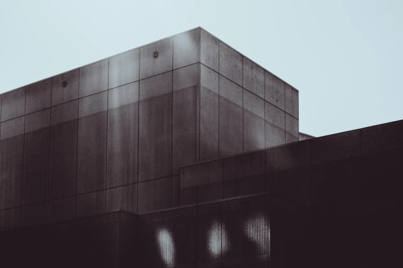 a large gray building sitting behind a fence