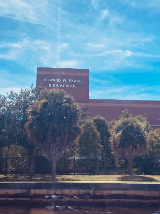 there is a building next to trees and a body of water