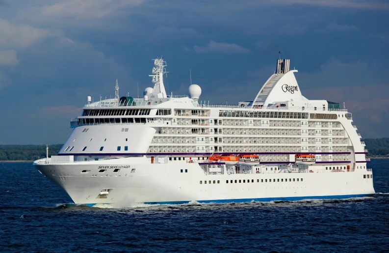 a cruise ship sailing in the ocean near another large white boat