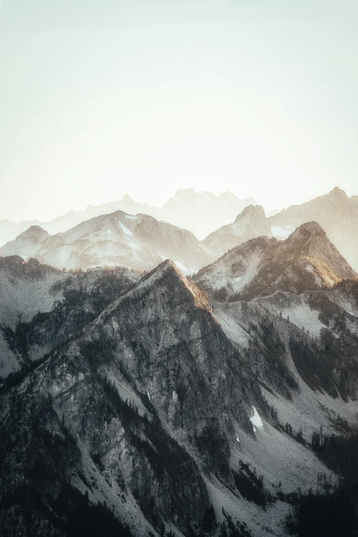 the top of mountains are covered with clouds