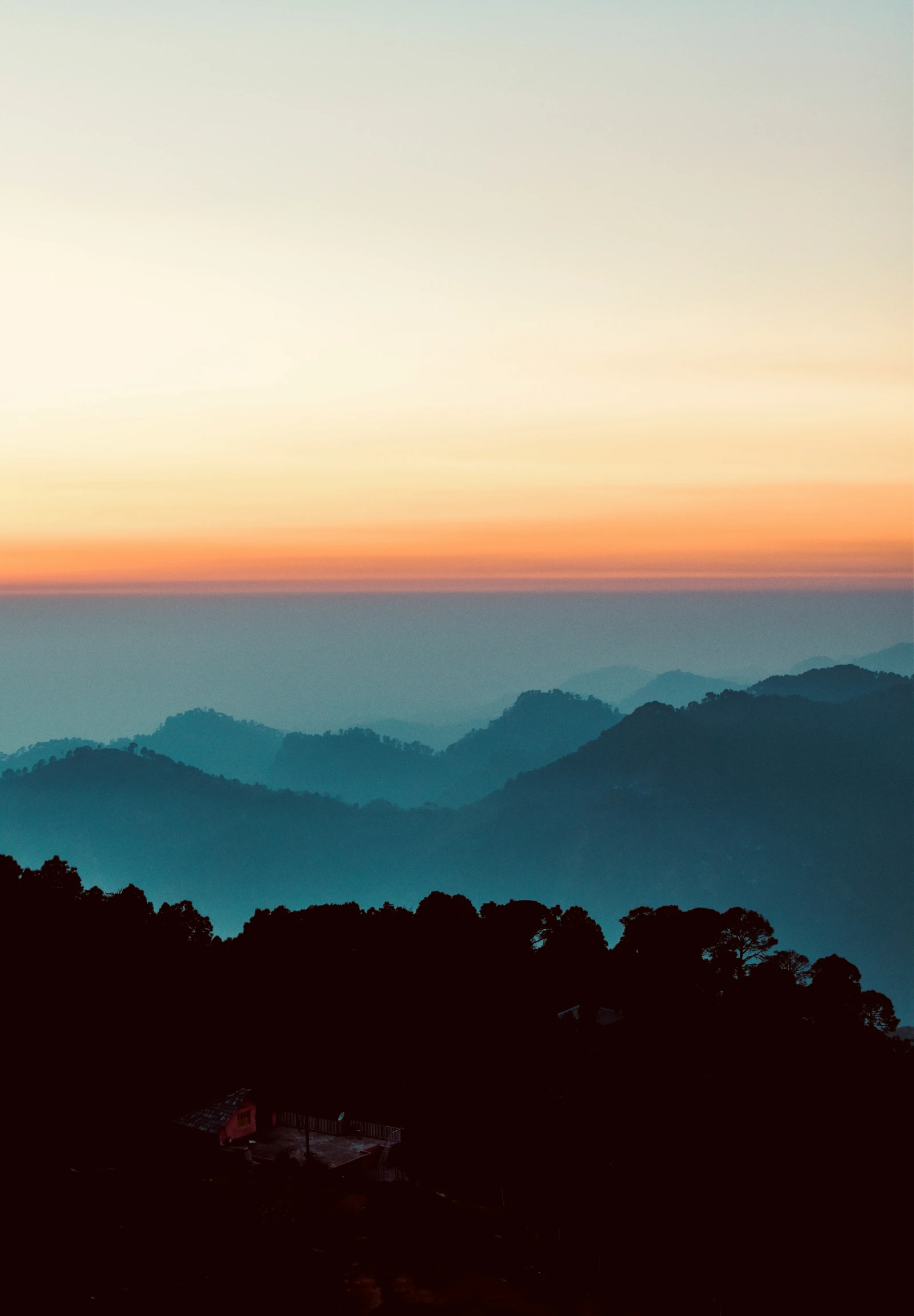 there is a picture taken at dusk from top of the mountain