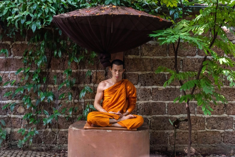 a monk is sitting down in a little area