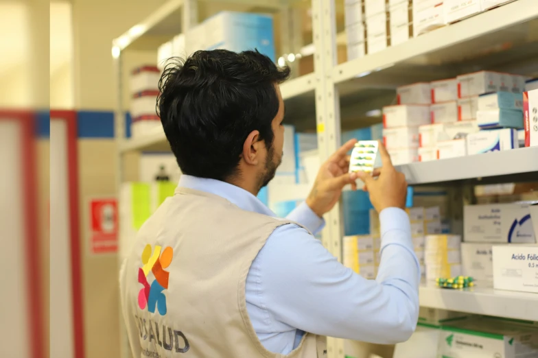 a man at the pharmacy choosing medicine in his pharmacy