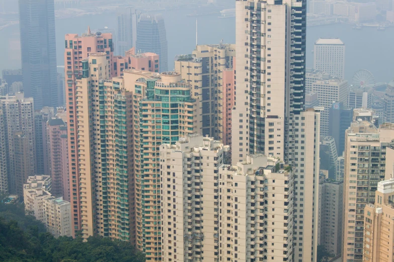 large skyscrs stand above tall buildings in the city