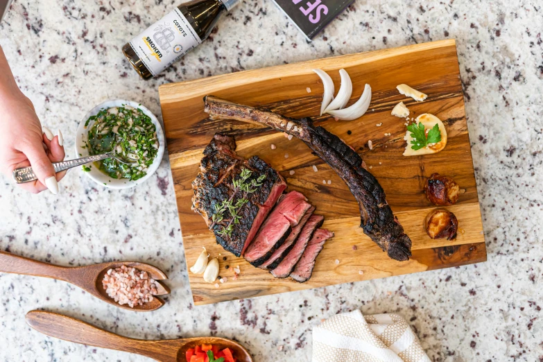 a knife is resting on top of a sliced steak