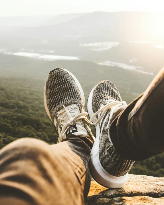 feet sticking out from the top of a mountain