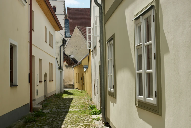 a alleyway with an old building in the background