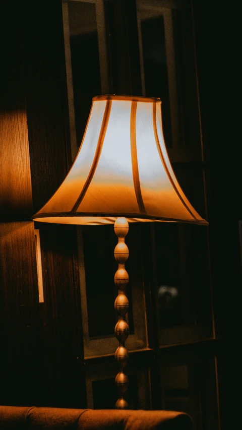 an old lamp and shades on a night stand