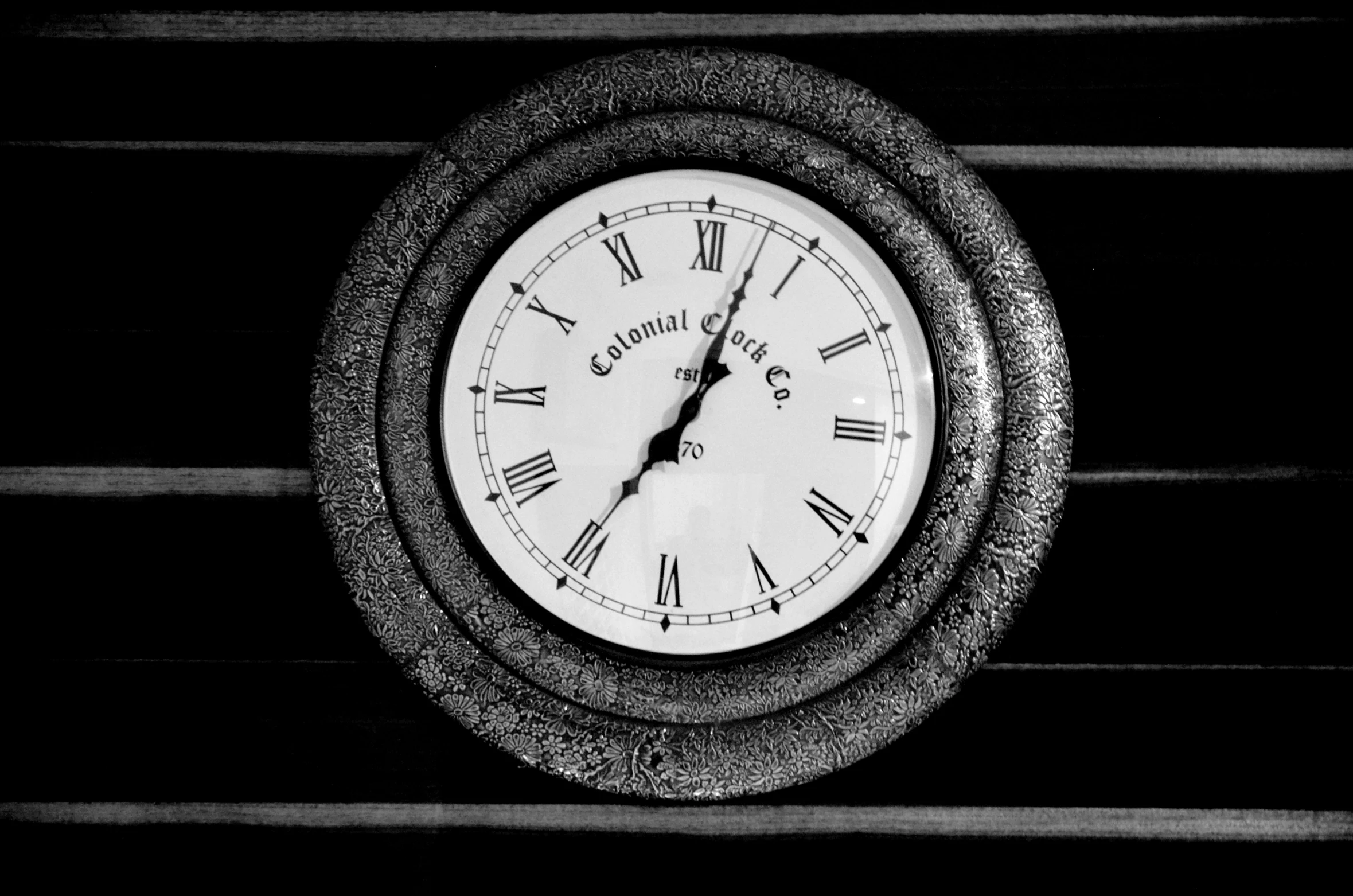an old clock is displayed in black and white