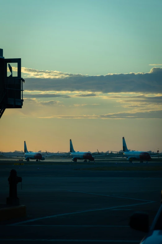 two airplanes are on a landing strip at an airport