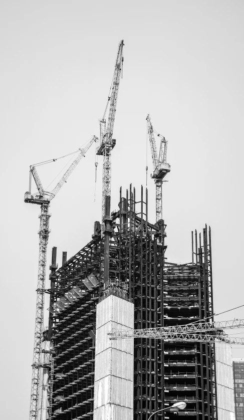 construction cranes are over building under construction