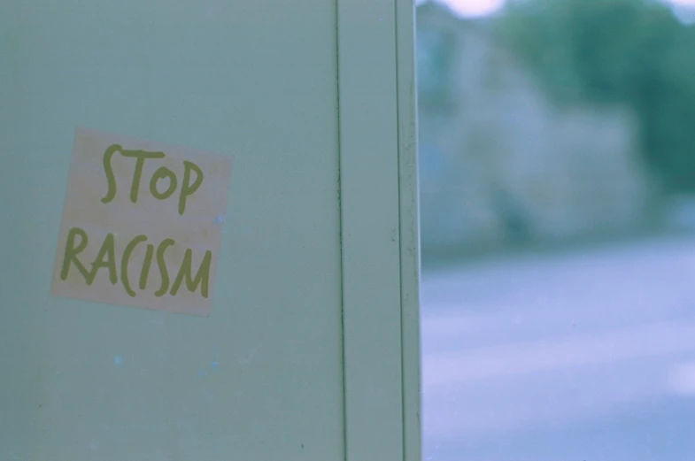 stop racism sticker on a metal door