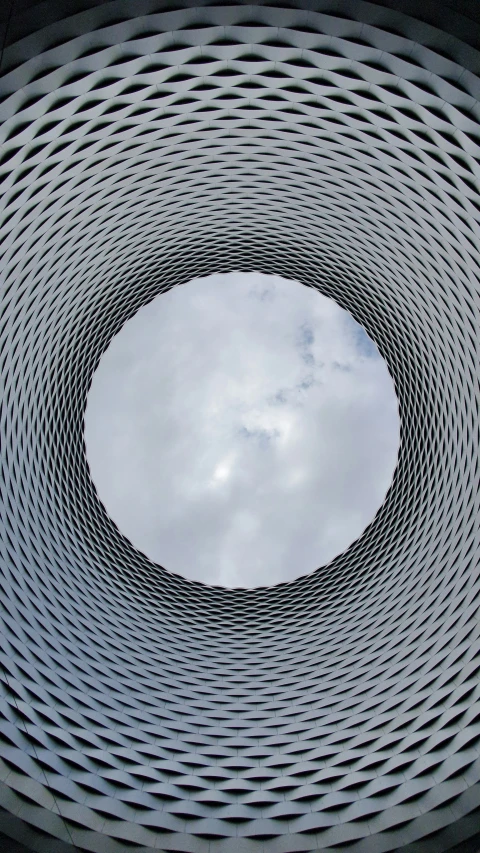 looking up at a very tall structure with circular windows