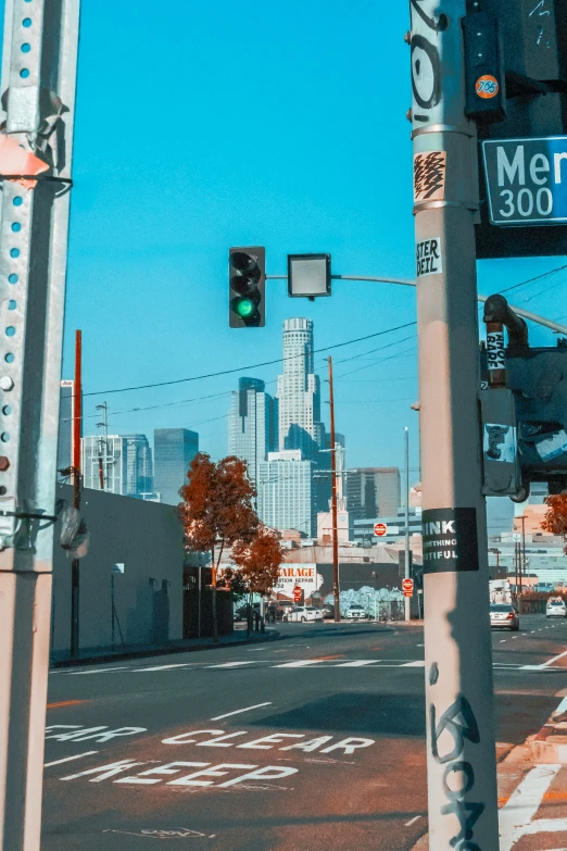 the stop light has a large city skyline in the background