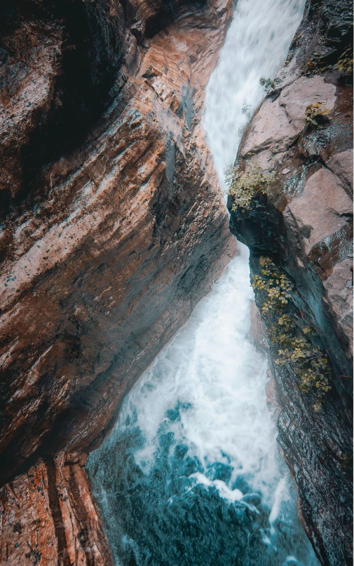 a large waterfall falling down into a canyon