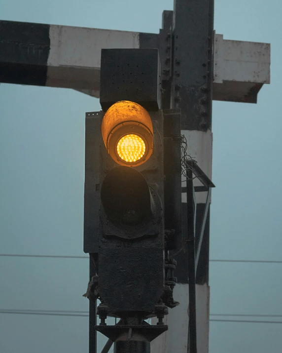 an empty traffic signal that is hanging on a pole