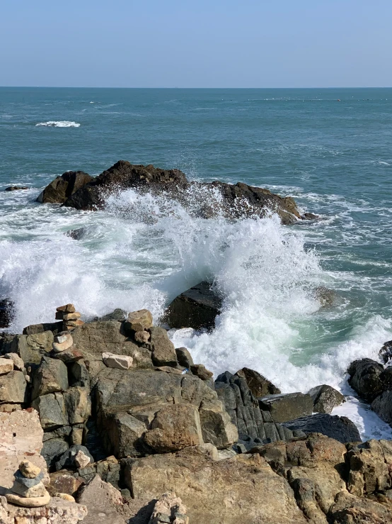 a body of water near rocks in the ocean